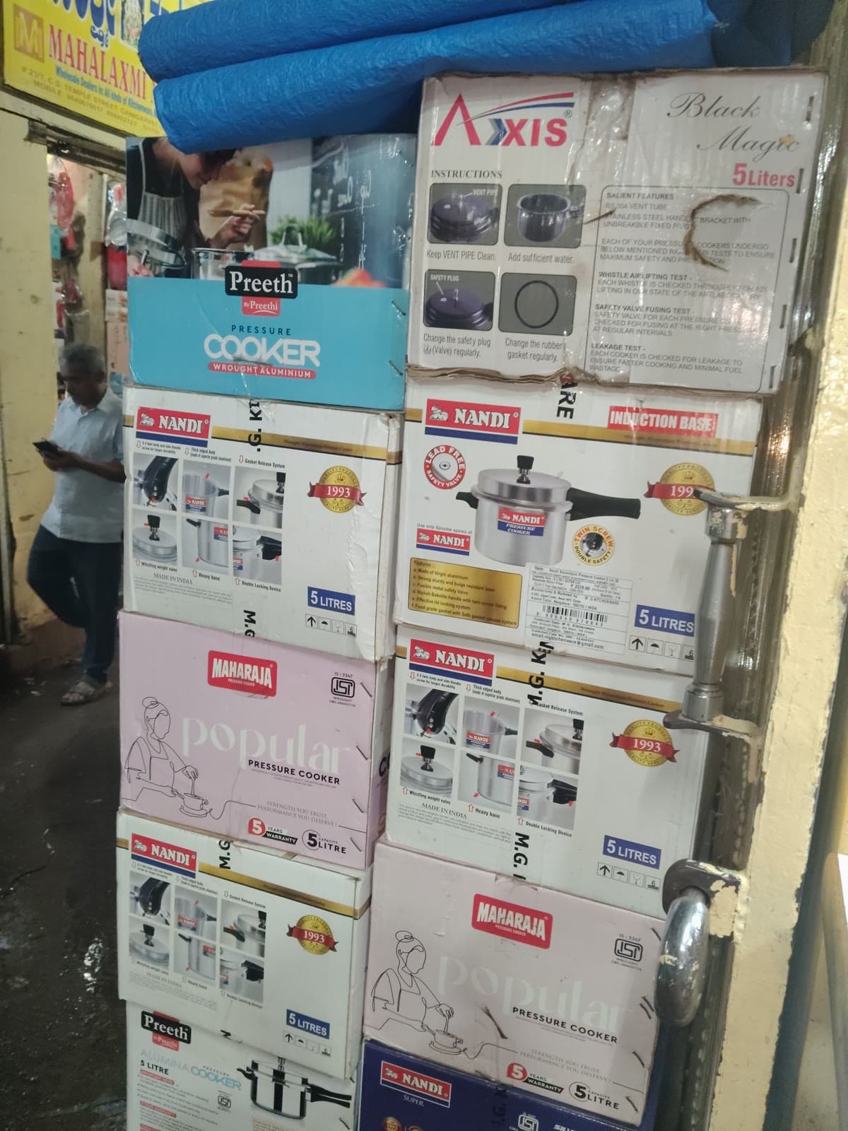 Wholesale counter with boxed mixers, stoves, pans, and kitchen appliances
